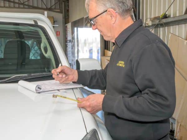 Gary Hansen filling out GVM upgrade paperwork at Hansen Automotive.